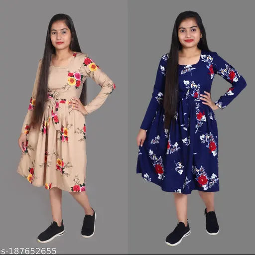 This is an image of a woman modeling two distinct styles of crop tops. The first style, positioned on the left, features a beige kameez with floral embroidery detailing, while the second style, on the right, showcases a navy blue kameez with similar floral embellishments. Both are designed in a cropped, knee-length silhouette and appear to have long sleeves. The background is minimalistic, allowing the focus to remain on the clothing items