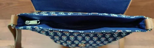 Navy blue cross-body sling with shoulder straps and adjustable buckle closure
