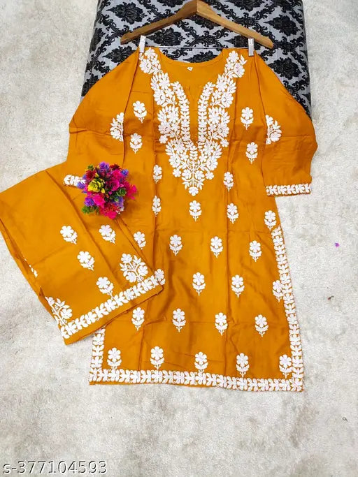 SLUB Rayon solid Chikankari fancy suit in cotton straight kurta with printed net skirt, three-quarter sleeves. Indian handcrafted fashion on display