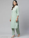 A woman wearing a matching kameez and salwar suit in blue patterned fabric