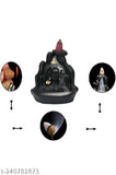 Black polyresin Shiv incense burner, featuring Adiyogi Shiva meditating by a backflow waterfall, comes with 10 cones for decorative use. Handcrafted in India