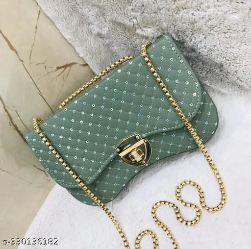 Light blue faux leather clutch with gold chain strap, small circular logo and metal hardware