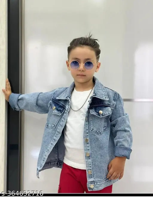 Boy in blue jean jacket leaning against wall