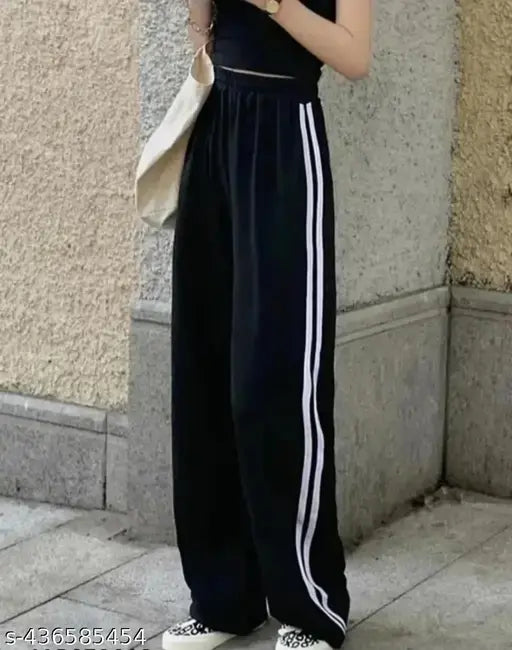 Black high-waisted baggy trousers with white piping details
