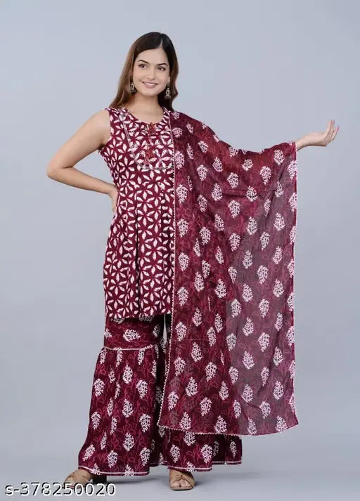 The image features a woman wearing a maroon and white long-sleeve sharara suit with a matching dupatta