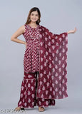The image features a woman wearing a maroon and white long-sleeve sharara suit with a matching dupatta
