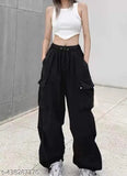 Black denim pants with a cropped top and rolled sleeves