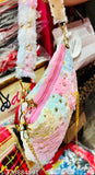 Fur sling bag with gold chain straps, black and white fur lining