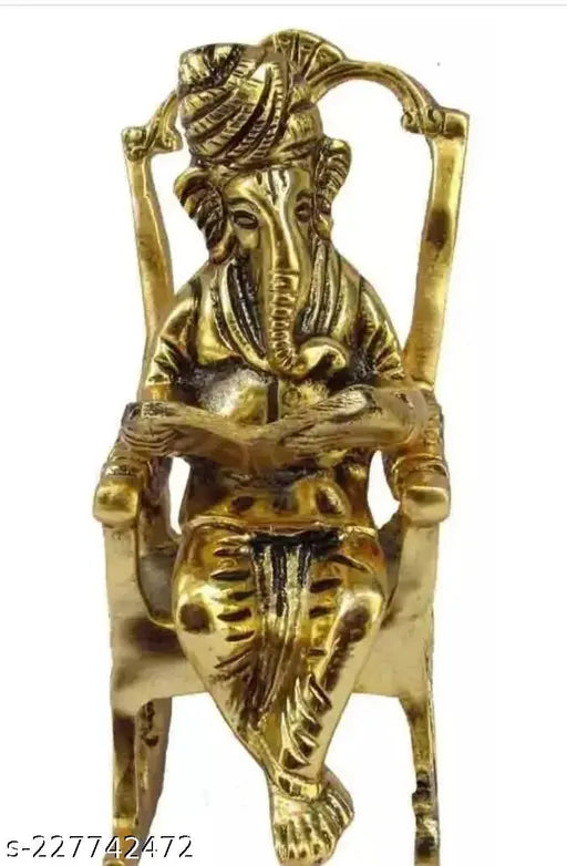 Metal Ganesha figurine sitting on a chair reading Ramayan, decorative showpiece for corporate gifts