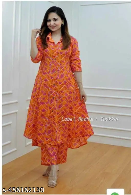 Orange leheriya rayon kurta and palazzo set, three-quarter sleeves, printed net pattern. Women's and girls' summer party wear. Beautifully designed A-line gathered dress in slender silhouette