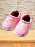 Pink and white baby slippers