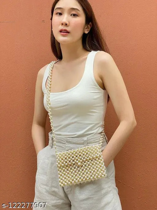Decorative white pearl cross-body bag with bead details. Luxury evening purses. Pearl and beaded design