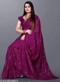 The image shows a woman in a vibrant purple saree with a glossy embroidered pallu, accessorized with what appears to be a red bindi on her forehead and red bangles on her wrists. She is wearing high-heeled shoes and has a traditional blouse piece paired with the saree