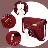A brown leather crossbody bag with a zip closure, multiple card slots, and a keyring charm