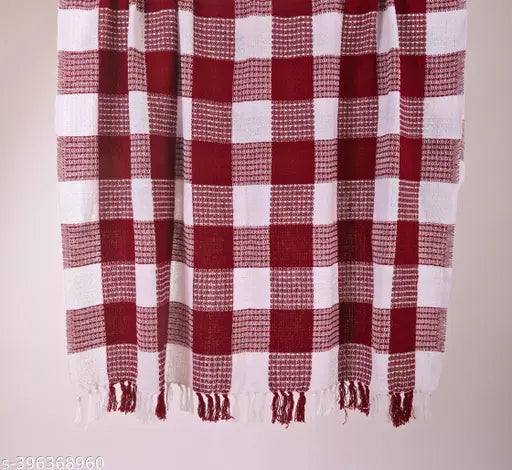 This is a red and white checkered throw blanket, designed for a two seater sofa. It's labeled as 'Premium Throw lines design Sofa Throw Blanket Cover For 2 Seater Sofa Throws For Home Decor Crib Size', which suggests that it is a high-quality blanket intended to complement a two seater sofa and enhance the aesthetic of a home decor setting. The blanket's red and white color scheme gives it a classic, timeless appeal. Its design features neat lines and a checkered pattern, which adds to its visual appeal