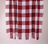 This is a red and white checkered throw blanket, designed for a two seater sofa. It's labeled as 'Premium Throw lines design Sofa Throw Blanket Cover For 2 Seater Sofa Throws For Home Decor Crib Size', which suggests that it is a high-quality blanket intended to complement a two seater sofa and enhance the aesthetic of a home decor setting. The blanket's red and white color scheme gives it a classic, timeless appeal. Its design features neat lines and a checkered pattern, which adds to its visual appeal