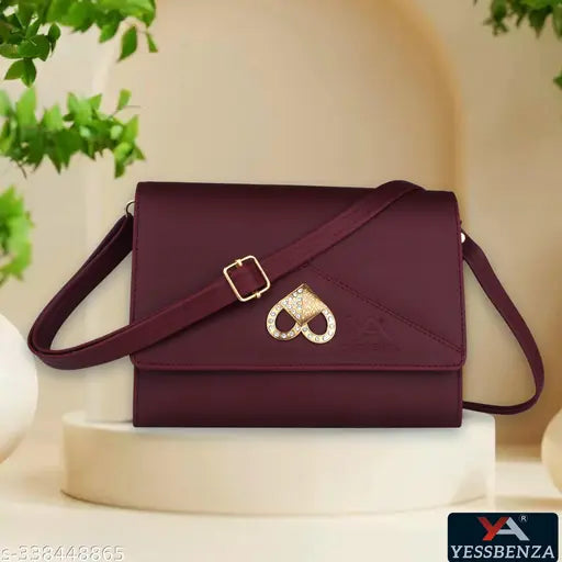 Brown sling bag with a heart charm closure