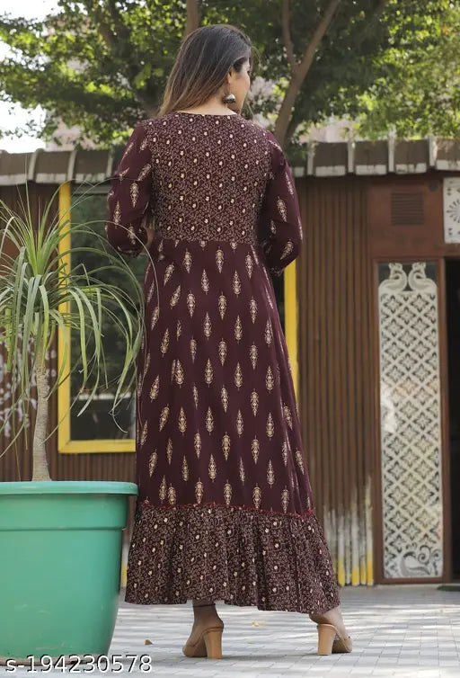 A woman in a long kurta with embroidered details, likely party wear or ethnic fashion