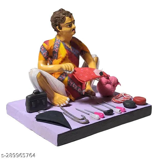A handcrafted clay figurine of a man, sitting, engrossed in repairing an umbrella, surrounded by various tools and materials indicative of his trade, placed on a desk or table