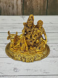 Golden oxidized metal Shiv Pariwar with Nandi statue, intricate Indian sculpture depicting deity Shiva and bull Nandi