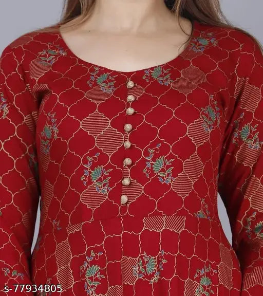 Red and blue patterned long sleeve top with a flared neckline, featuring a button closure at the front