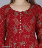 Red and blue patterned long sleeve top with a flared neckline, featuring a button closure at the front