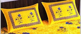 Yellow cotton bedsheet with floral design and decorative border.