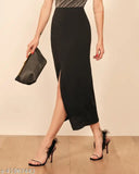 Black cotton blend pencil skirt, ankle length with center front slit and slim fit. Solid silhouette, high rise waist, elastic waistband. Ideal for crop tops, hoop earrings, and strappy heels." (120 characters)
