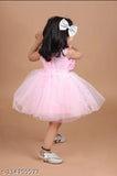 Pink tulle ball gown with ruffled hem and bow at waist