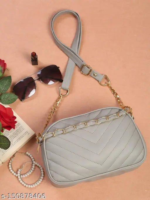 Fashionable cross-body women's bag with silver chains, large top zip closure, and adjustable shoulder straps