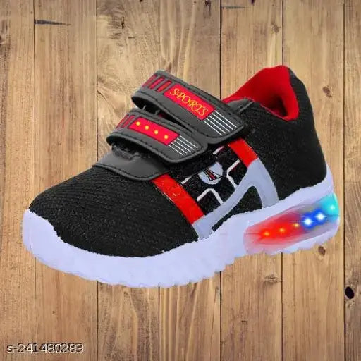 Black and red running shoes with LED light up features, designed for sports activities and featuring a comfortable footbed. The shoes have a black base color with striking red accents and bright LED lights on the soles. The design suggests they are suitable for kids and feature a snug fit for providing support during active play
