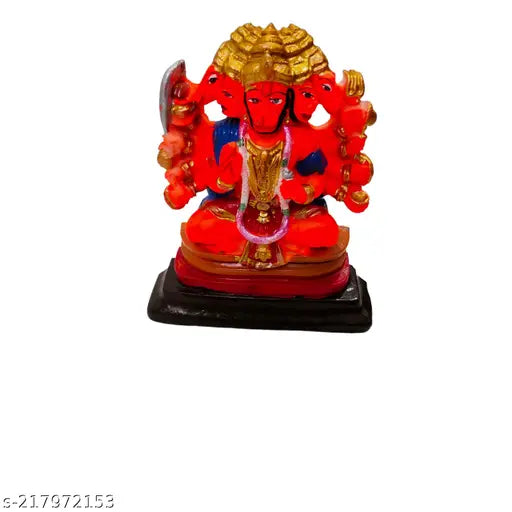 Red ceramic Ganesha idol, blue fabric backdrop