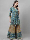 A peach colored flared kurta on a woman, featuring sharpas and a dupatta