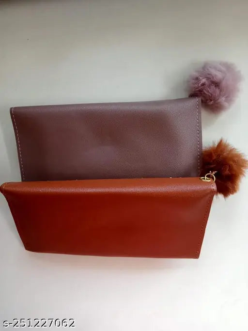 Brown leather clutch with a wool ball bow, 3 card slots, zip closure