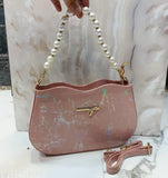 Stylish marble-like material sling bag with pearl detailing and multiple pockets for women's fashion accessories