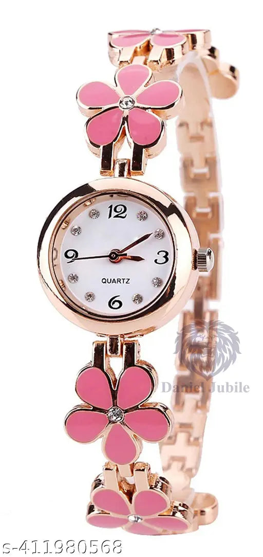 Pink analog watch with a floral charm, gold tone accents