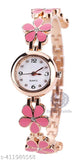 Pink analog watch with a floral charm, gold tone accents