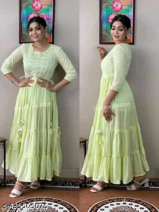 Light green floor-length dress with ruffled sleeves and embroidered details