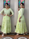 Light green floor-length dress with ruffled sleeves and embroidered details