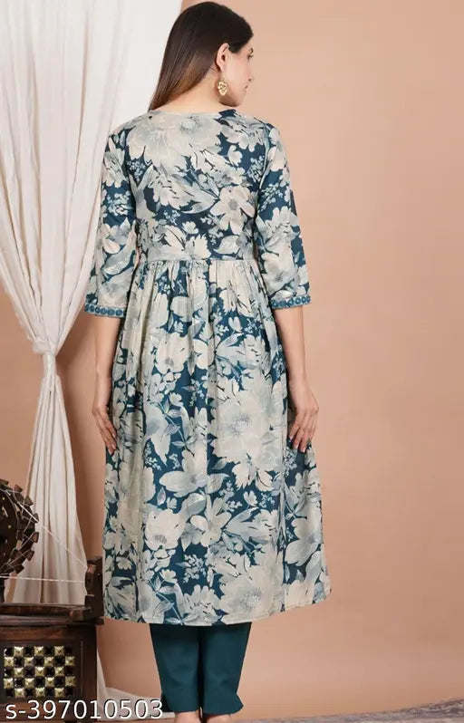 Aqua blue Rayon kurti with printed combo, three-quarter sleeves, and heavy embellishments. Indian handcrafted Aliya cut Kurti on model