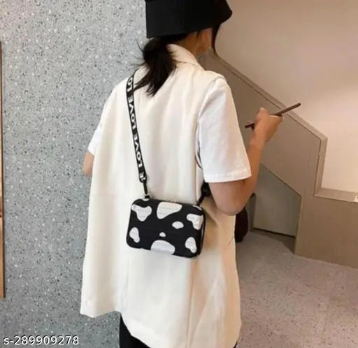 A compact black and white shoulder bag with a side purse compartment for girls