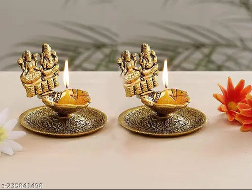Ganesh and Laxmi figure on traditional Indian diyas for home, office, or temple decoration