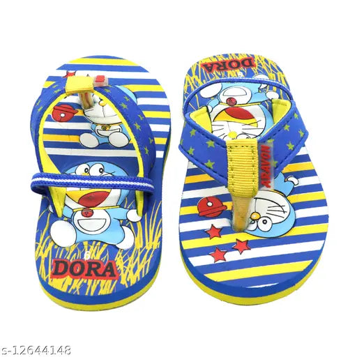 The image displays a pair of canvas sandals with blue and yellow patterns, featuring a cartoon character wearing red shorts. They are fastened with Velcro straps and are placed on what appears to be a wooden floor