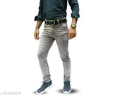 Black jeans with rolled-up cuffs and a black belt