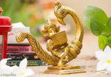 Gold oxide metal sitting baby Ganesh idol statue on peacock with book, 15x7x15.5 cm for Puja showpiece