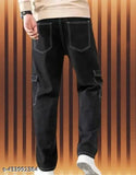 A person in a dark setting is wearing black men's cargo pants with 6 pockets. The pants are made of what appears to be a woven fabric, possibly cotton or denim, and have a classic design with two front pockets and four side pockets. There are no visible brand names or closure types in the image