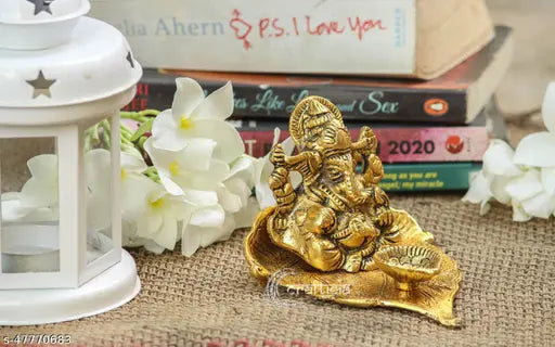 Gold oxide metal Crafticia Lord Ganesh on leaf with diya, religious showpiece for positive energy and auspicious start (11x9.5x7 cm)
