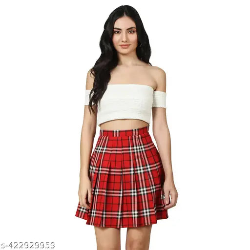 Red check pleated mini tennis skirt with attached shorts, high-quality polyester for active women's sports and casual wear. Available in sizes: 24/XS (waist 24in, hip 32in, length 17.5in), 26/S (waist 26in, hip 34in, length 17.5in), 28/M (waist 28in, hip 36in, length 17.5in), 30/L (waist 30in, hip 38in, length 17.5in), 32/XL (waist 32in, hip 40in, length 17.5in), 34/2XL (waist 34in, hip 42in, length 17.5in), 36/3XL (waist 36in, hip 44in, length 18in). Made in India