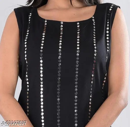 The image is of a person wearing a black sleeveless top adorned with sequins or crystals, paired with a matching long skirt that has a pattern on it