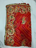 Red paisley embroidered sari with intricate details and border